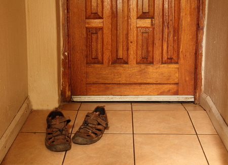 Old sandals outside a doorの写真素材