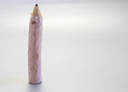 A pink pencil on a white background - landscape formatの写真素材