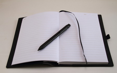 Open note book with empty pages and a penの写真素材
