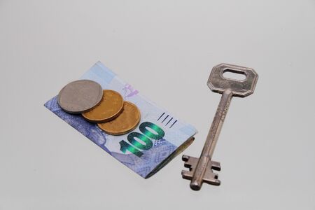 A key and money - unlocking wealthの写真素材