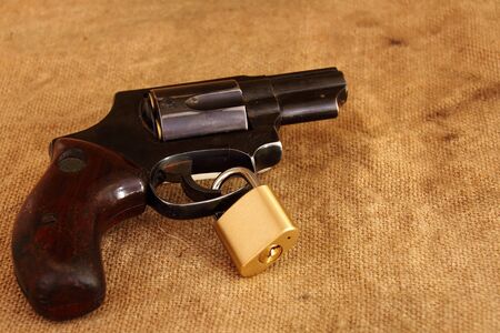 A handgun with a lock around the trigger