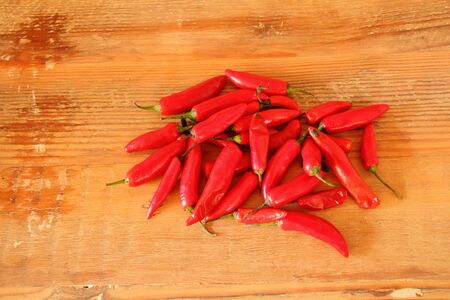 Red chillies on a wood surface