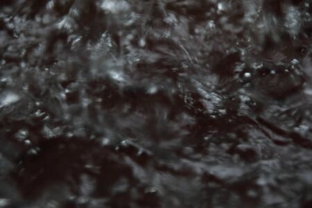 Abstract predominantly brown background with out of focus tumbling water in landscape formatの写真素材