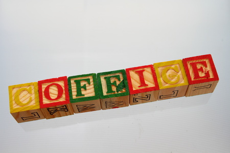 The term coffice displayed visually on a soft blue background using colorful wooden toy blocks in...