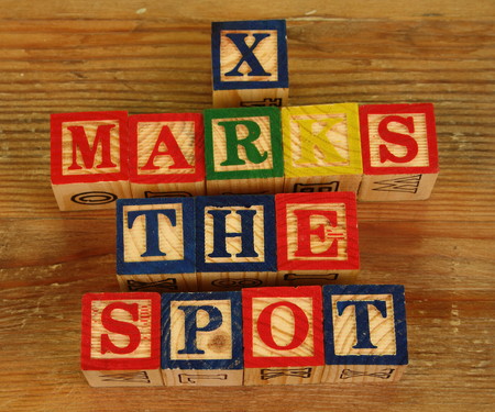 The term X marks the spot visually displayed using colorful wooden blocksの写真素材