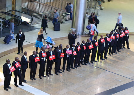 Johannesburg South Africa - courtesy vehicle drivers line up in the arrivals hall of the O.R.Tambo...