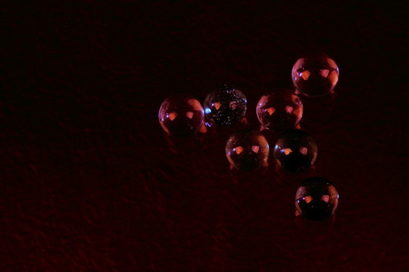 Futuristic presentation image of glass spheres with human-like eyes on a dark background in landscape format with copy spaceの写真素材