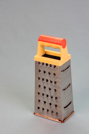 Metal box grater on clear background in portrait format with copy spaceの写真素材