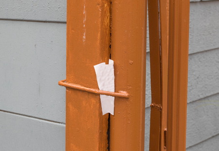 Note stuck in a gatepost image in landscape format with copy space