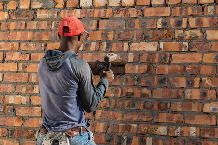 Cape Town, South Africa - a general laborer works on a building site as daily life continues despite the water crisis that threatens the city image in landscape format with copy spaceの写真素材