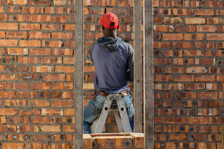 Cape Town, South Africa - a general laborer works on a building site as daily life continues despite...