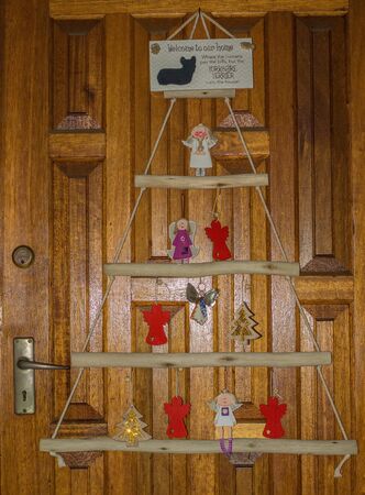 Christmas decorations on the wooden front door of a house image in vertical formatの写真素材