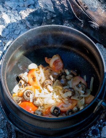 Cooking food outdoors in a cast iron pot is an Afrikaner tradition image in vertical formatの写真素材