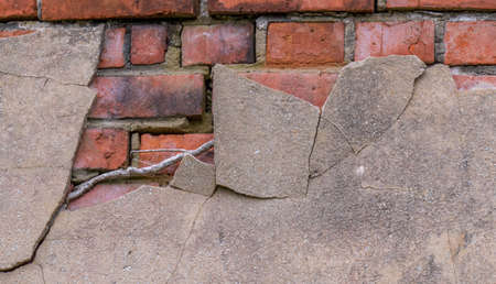Exposed brickwork and cracked cement in a dilapidated old building image in horizontal formatの写真素材