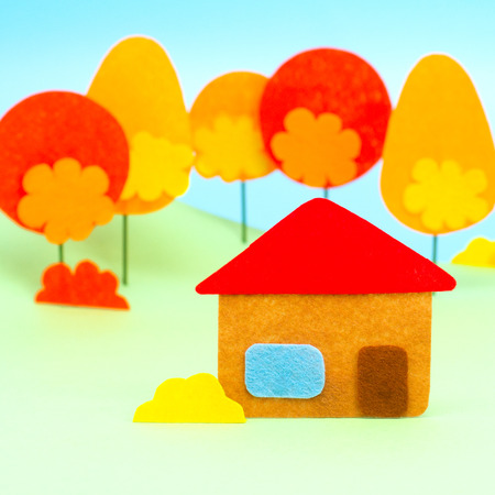 Autumn red orange trees and rustic house window stand  clean fresh quiet forest against blue sky backgroundの写真素材