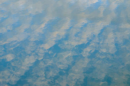 Blue Sky reflected on the surface of the waterの写真素材