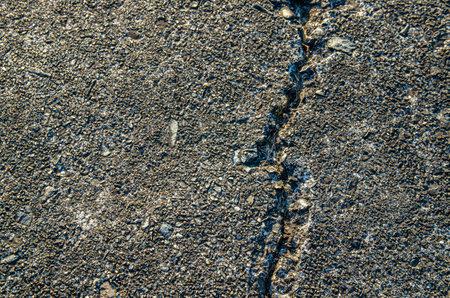 Cracks in the road surfaceの写真素材