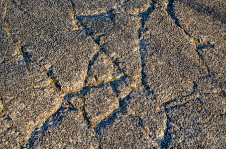Cracks in the road surfaceの写真素材