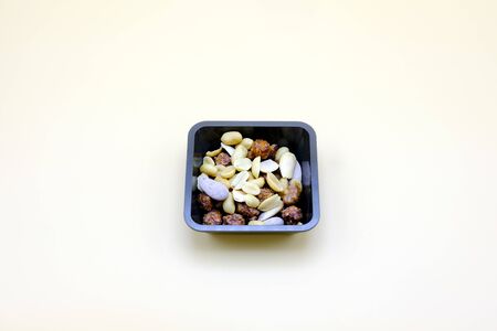 Set of Almonds and peanuts in a bowl isolated on orange backgroundの写真素材