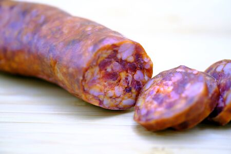 cut  sausage called in spanish chorizo ,  typical of Spain. On a wooden board