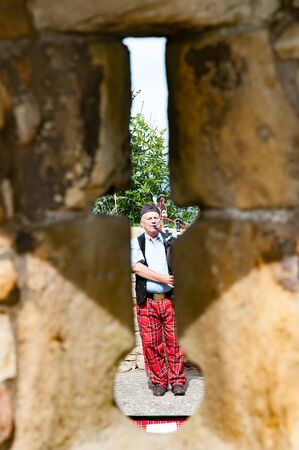 ST ANDREW, SCOTLAND, UK, September 17, 2016.Piper playing the bagpiper in the  Ruins of St. Andrew's Cathedral,のeditorial素材