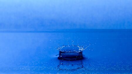 drop water splash and make perfect circles on the waterの写真素材