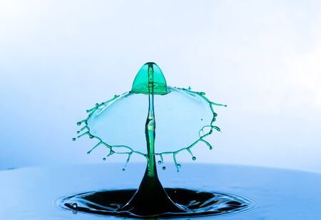 Falling drops of water. Splash effect after collision a falling drops with water Surfaceの写真素材