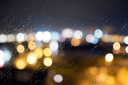 Drops of rain and lights on the window (glass) at the night. Shallow DOFの写真素材