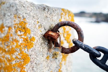 Paddles and chain rotten by the sea saltpetre in the battlement of a medieval castle on an island near La Coruna, Galicia, Spainの写真素材
