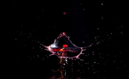 Images forming two drops of water when colliding after falling in waterの写真素材
