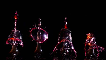 Images forming two drops of water when colliding after falling in waterの写真素材
