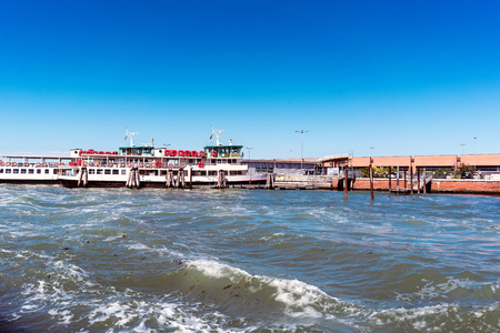 Venice, Veneto / Italy- May 20, 2017: Industrial buildings and boat dock on the canal to the sea of veniceのeditorial素材