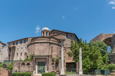 View of the various ruins of the Roman Forum with a very blue sky slightly cloudy without people in sightのeditorial素材