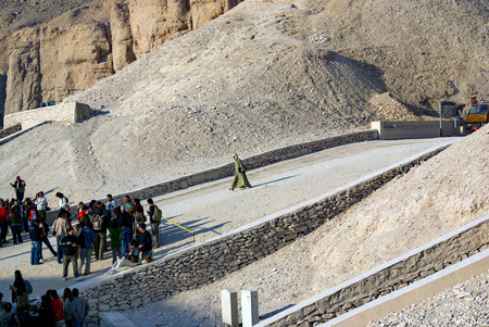 Luxor, Egypt, February 16, 2016. Side view of the entrance to the tomb of Pharaoh Tutankhamun in the Valley of the Kings with tourists visiting himのeditorial素材