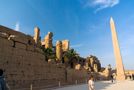 Luxor, Egypt. February 20, 2017: Obelisk of the temple of Luxor, twin of the one located in Paris, and wall of the ruins of the temple, full of hieroglyphics and with tourists visiting itのeditorial素材
