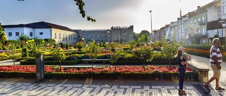 Braga, Portugal. August 14, 2017: Santa Barbara Garden and facade of the former archbishop's palace. Photo with the sun in front and with an elderly couple of touristsのeditorial素材