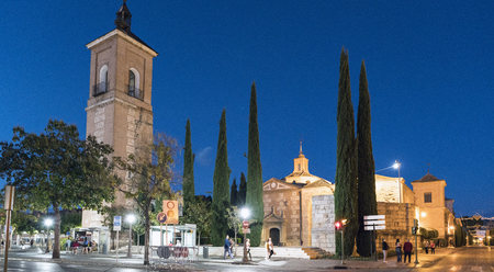 Alcala de Henares, Madrid, Spain. December 8, 2017; Night shot of the Tower of the Church of Santa Maria and Plaza de Rodriguez Marín with many people walkingのeditorial素材