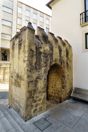 Detail of the remains of a medieval stone gate located next to the facade of the National Museum called de Machado Castro in Coimbra, Portugalのeditorial素材