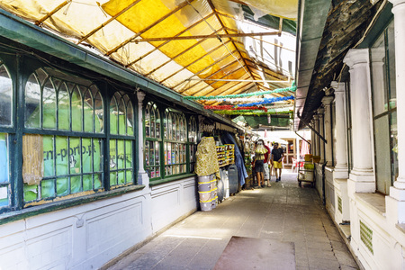 Porto, Portugal. August 12, 2017: Corridor with closed stalls of the neoclassical market known as Do Bolhao in the center of the city with tourists looking at an open food stand at the endのeditorial素材