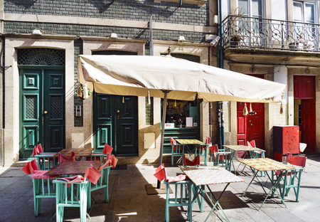 Empty terrace of a bar with sunbeds in a typical commercial of Flowers in the center of Porto (Portugalの写真素材