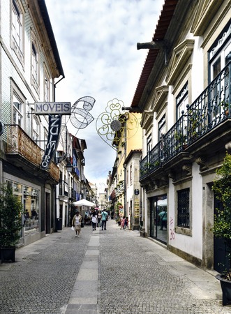 Viana do Casterlo, Portugal. August 15, 2017: Commercial street in the center of town with cobblestones and people passing by. View of the illumination (turned off) by the feast of the virgin of agonyのeditorial素材