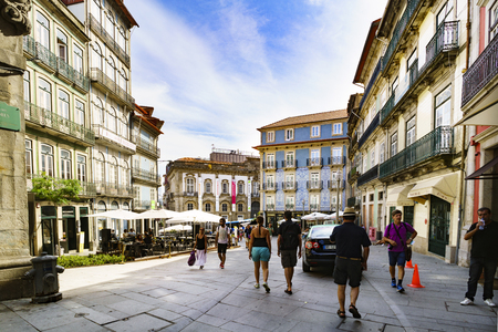 Porto, Portugal. August 12, 2017: Commercial street of Flowers in the center of the city with tourists strolling and a nice house with blue tiles in the backgroundのeditorial素材