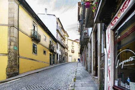 Porto, Portugal. August 12, 2017: Street with a strong paved cobblestone slope in the center of the city called "Taipas" very lonely and with facades of old housesのeditorial素材