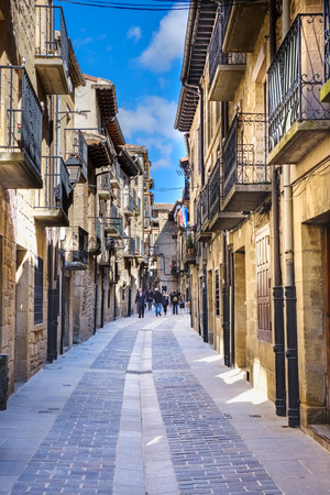 Laguardia, Alava, Spain. March 30, 2018: Main street of the town called Mayor with facades of stone houses and iron balconies typical of northern Spain and people passing through it. Stone paving floorのeditorial素材