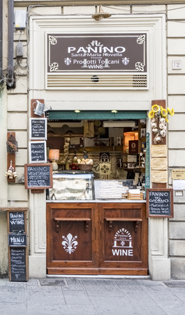 Typical small store called Panino in the square of Sata Maria Novella selling food with posters painted with chalk in its frameのeditorial素材
