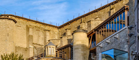 Detail of the upper back part of a very old stone church located in the old town of Vitoria, Spain with towers and buttressesの写真素材