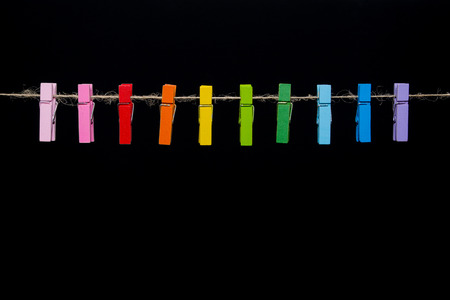 colored wooden clothespin on hemp ropeの写真素材