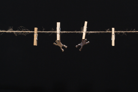 metallic man on hemp rope with wooden clothespinの写真素材