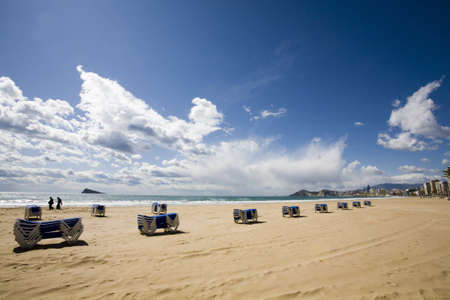 deck chairs on a beach in benidormの写真素材