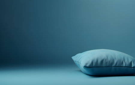 Blue pillow on blue background with copy space. 3D rendering.の素材